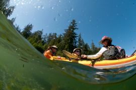 family in triple kayak