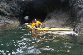 sea kayaking near rock arches and caves