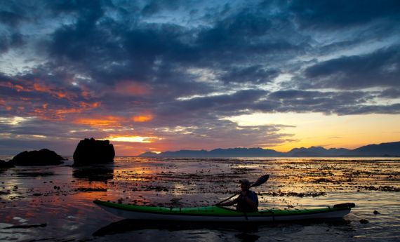sea kayaker with sunset in Kyuquot, BC