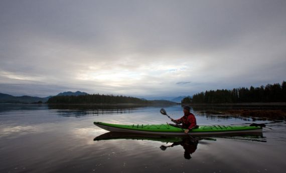 sea kayaker at sunsrise in calm bay at Spring Island