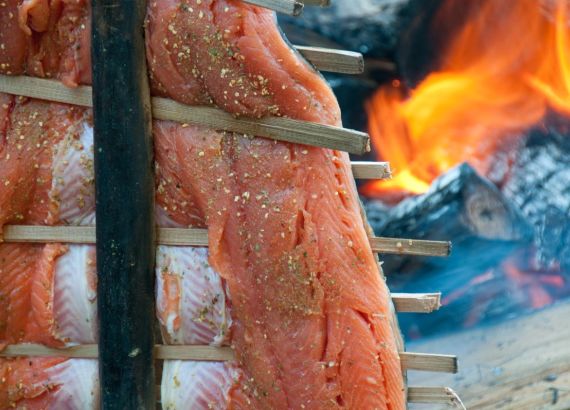 salmon cooking beside fire